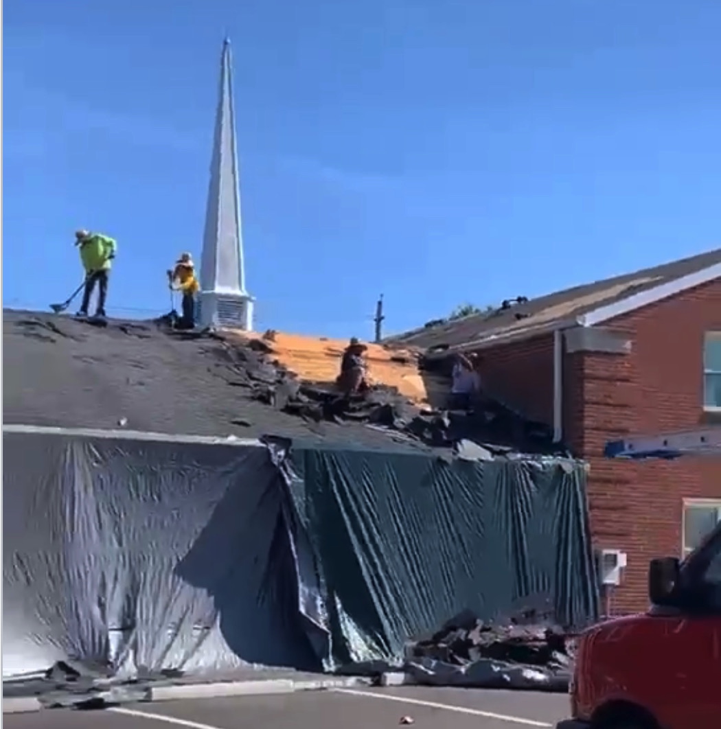 Roofers working on building